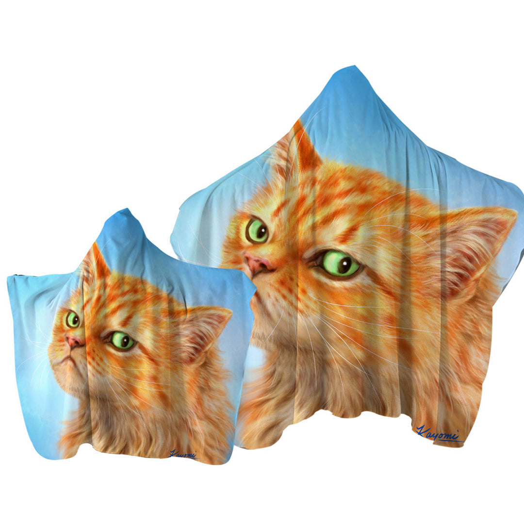 Suspicious Ginger Cat over Blue Hooded Beach Towel